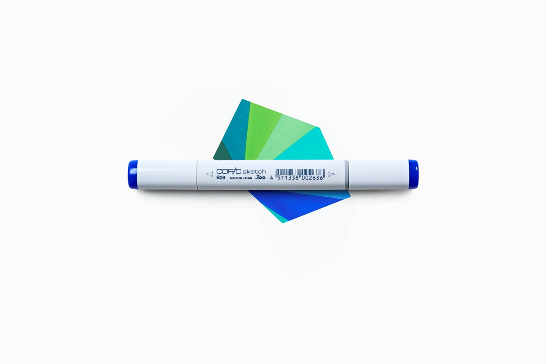 A piece of paper colored with Copic Sketch in different shades of blue and green